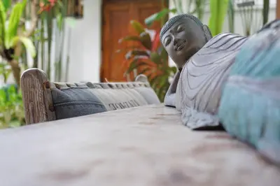 a statue of a man sitting at a table at T&J1 - Gorgeous 1BR pool villa, parking, walk to beach! in Umalas