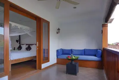 a living room with a blue couch and a bed at T&J1 - Gorgeous 1BR pool villa, parking, walk to beach! in Umalas