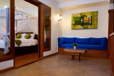 a room with a blue couch and a bed at T&J1 - Gorgeous 1BR pool villa, parking, walk to beach! in Umalas