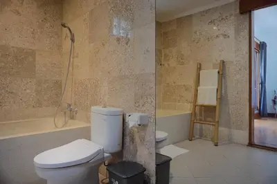 a bathroom with a toilet and a shower in it at T&J1 - Gorgeous 1BR pool villa, parking, walk to beach! in Umalas
