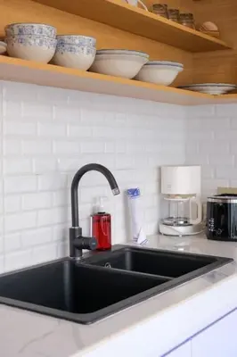 a kitchen sink with cups and bowls on a shelf at T&J4 - Romantic 1BR pool villa, walk to beach in Umalas