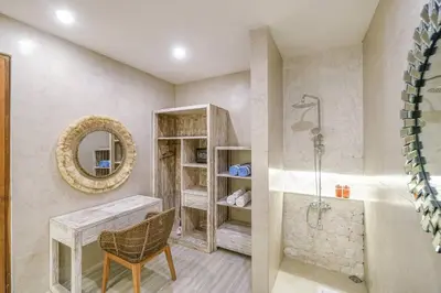 a bathroom with a tub and a table and a mirror at T&J4 - Romantic 1BR pool villa, walk to beach in Umalas