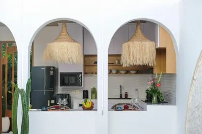 a kitchen with two arched windows and a refrigerator at T&J4 - Romantic 1BR pool villa, walk to beach in Umalas