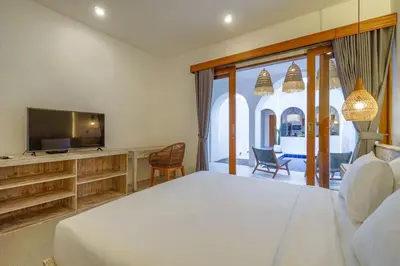 a bedroom with a large bed and a television at T&J5 - New! Romantic 1BR pool villa, walk to beach! in Umalas