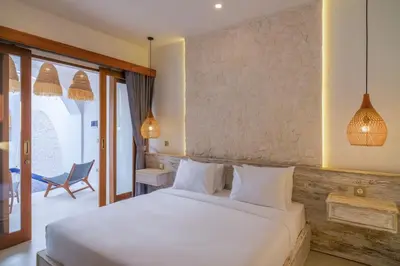 a bedroom with a white bed and a chair at T&J6 - Gorgeous 1BR pool villa, walk to beach! in Umalas