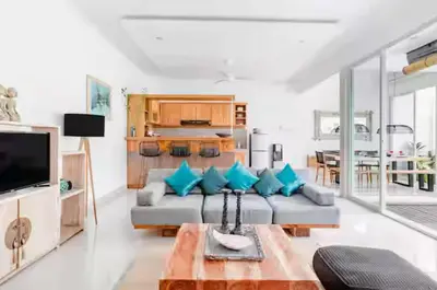 a living room with a couch and a table at 2 villa complex near Atlas beach in Canggu