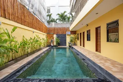 a swimming pool in the middle of a building at Cove Kavana in Canggu