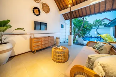 a living room with a couch and a table at Free pick-up Balinese style tropical private pool villa with 2 bedrooms in Seminyak