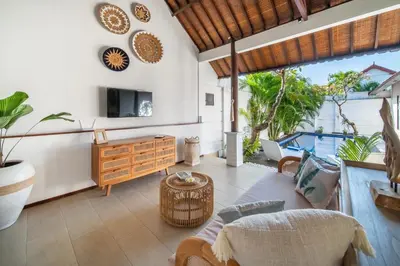 a living room with a couch and a table at Free pick-up Balinese style tropical private pool villa with 2 bedrooms in Seminyak
