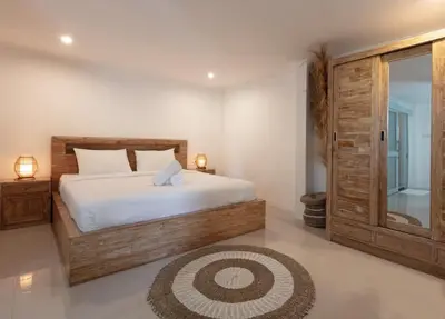 a bedroom with a large bed and a glass door at Braban Sari Bali in Seminyak