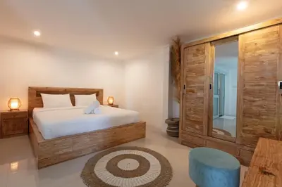 a bedroom with a bed and a glass door at Braban Sari Bali in Seminyak