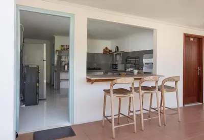 a kitchen with a table and two stools at Braban Sari Bali in Seminyak