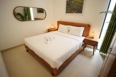 a bedroom with a bed with a teddy bear on it at Canggu Zen Villa - 2 BR Villa in Berawa in Canggu