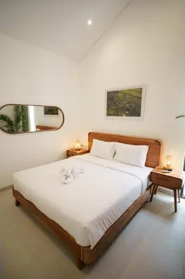 a bedroom with a bed with two teddy bears on it at Canggu Zen Villa - 2 BR Villa in Berawa in Canggu