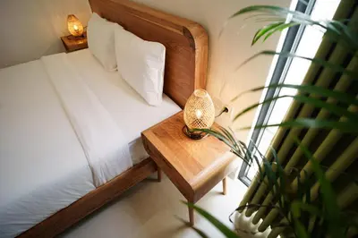 a bedroom with a bed and a table with a plant at Canggu Zen Villa - 2 BR Villa in Berawa in Canggu
