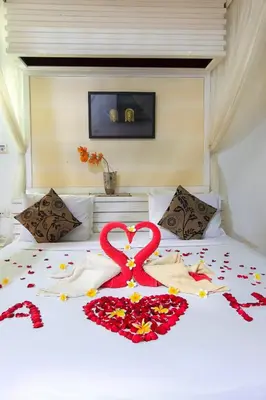a bed with a heart made out of flowers on it at LV Villa Kuta Bali in Jimbaran