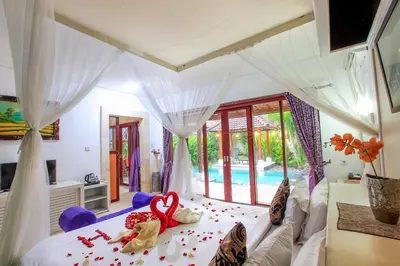 a bedroom with a bed with a heart on it at LV Villa Kuta Bali in Jimbaran