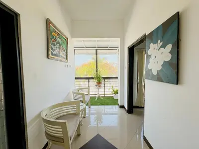 a room with chairs and a table and a window at Bby Diamond Villa in Seminyak