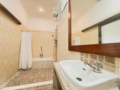 a bathroom with a sink and a mirror and a shower at Bby Diamond Villa in Seminyak