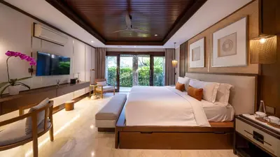 a bedroom with a large bed and a television at Villa Asta in Seminyak