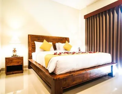 a bedroom with a large bed with roses on it at Le Retreat Canggu, 3BR Luxury Villa, Bali's Best Location in Canggu
