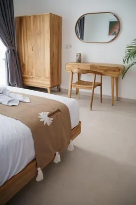 a bedroom with a bed and a desk and a mirror at Berawa 2BR Private Pool Leon Villa by Bali Bliss Properties in Canggu
