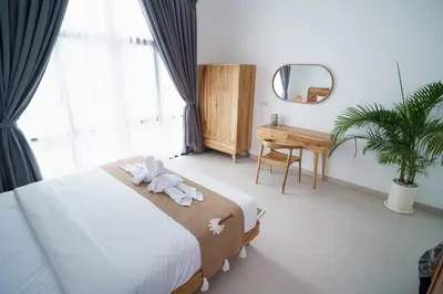 a bedroom with a bed with a stuffed animal on it at Berawa 2BR Private Pool Leon Villa by Bali Bliss Properties in Canggu