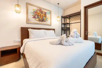 a bedroom with two towels on a bed at Miles Coliving in Kerobokan
