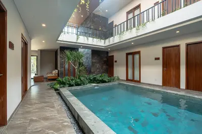 an indoor swimming pool in a house with an indoor at Miles Coliving in Kerobokan