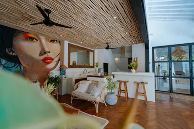 a living room with a large painting of a woman at Villa bossa nova in Seminyak