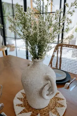 a vase with flowers in it sitting on a table at Villa bossa nova in Seminyak