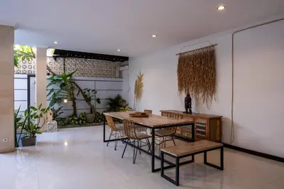 a dining room with a table and chairs at Villa Yuhi in Seminyak