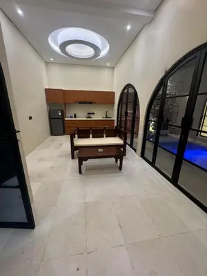 a living room with a bench in the middle of a room at Antanaya Villa Seminyak in Seminyak