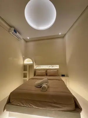 a bedroom with a large bed with a white ceiling at Antanaya Villa Seminyak in Seminyak