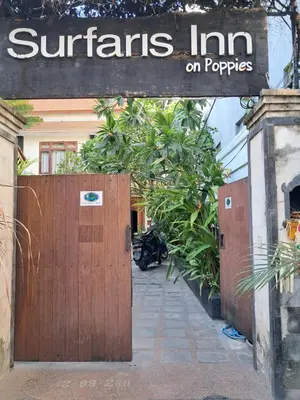 a wooden gate with a sign that reads nutrients inn on puppies at SURFARIS INN on poppies 2 in Legian
