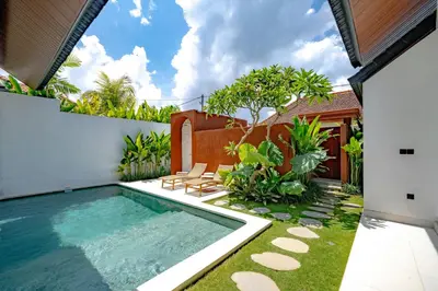 a swimming pool in the backyard of a house at Casa Umari in Canggu