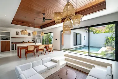 an open living room and dining room with a large window at Casa Umari in Canggu