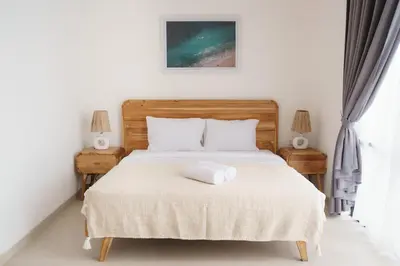 a bedroom with a bed with a white towel on it at Mau Villa by Bali Bliss Properties in Canggu