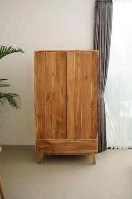 a wooden cabinet in a room next to a window at Mau Villa by Bali Bliss Properties in Canggu