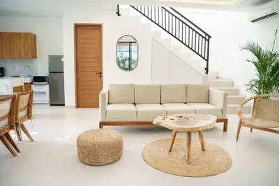 a living room with a couch and a table at Mau Villa by Bali Bliss Properties in Canggu