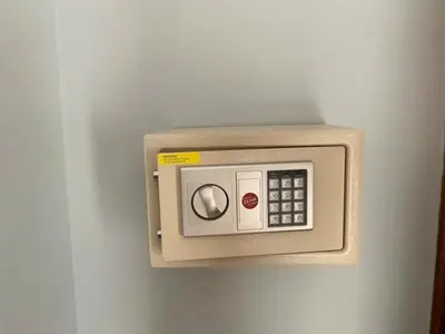 a wall mounted microwave on a white wall at Villa D Lima Top Floor in Kuta