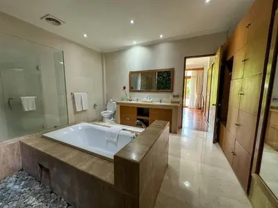 a large bathroom with a tub and a sink at Party Size 4 Bedroom Villa Kerobokan in Seminyak