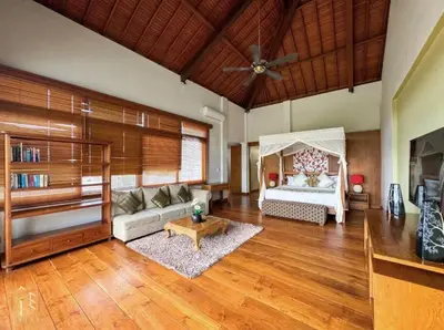 a living room with a couch and a ceiling fan at Party Size 4 Bedroom Villa Kerobokan in Seminyak