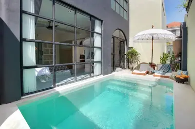 a swimming pool in the middle of a house at Casa Ghitani Kerobokan 1 Bed Enclose Living room WH2 in Umalas