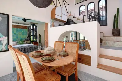 a dining room with a wooden table and chairs at Casa Ghitani Kerobokan 1 Bed Enclose Living room WH2 in Umalas