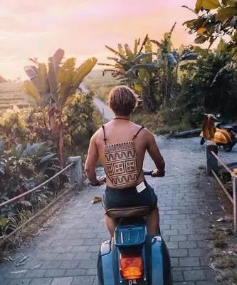 a man is riding a motorcycle down a path at Casa Ghitani Kerobokan 1 Bed Enclose Living room WH2 in Umalas