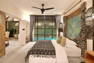 a bedroom with a bed and a large window at Casa Ghitani Kerobokan 1 Bed Enclose Living room WH2 in Umalas