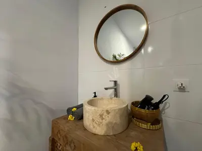 a bathroom with a sink and a mirror on the wall at 2 bedrooms villa cinta umalas in Kerobokan
