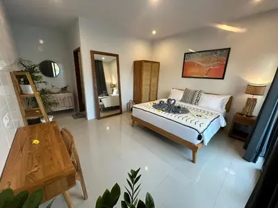 a bedroom with a bed and a table in it at 2 bedrooms villa cinta umalas in Kerobokan