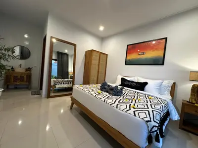 a bedroom with a large bed and a large mirror at 2 bedrooms villa cinta umalas in Kerobokan